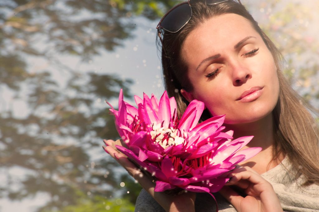 Look at the lady and the flower and the ocean below.